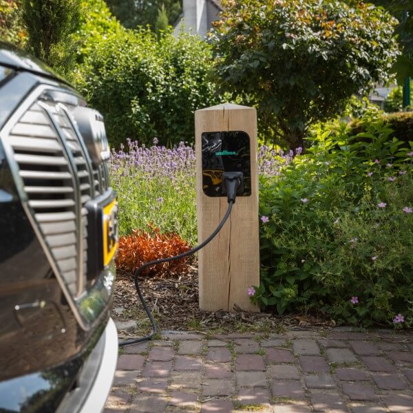 Charging electric car with wooden charging station