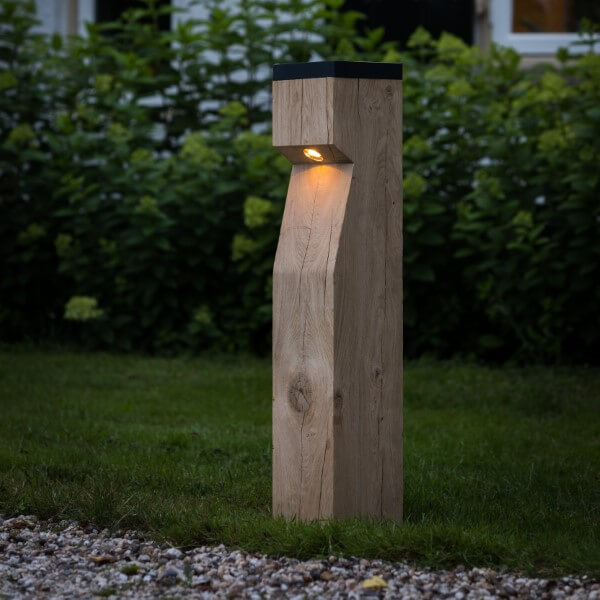 Sustainable wooden path lighting with solar panel in the garden