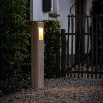 Wooden path lighting next to the fence along the path