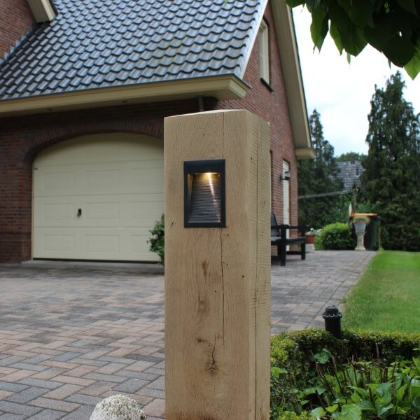 Wooden path lighting with black fixture along the driveway