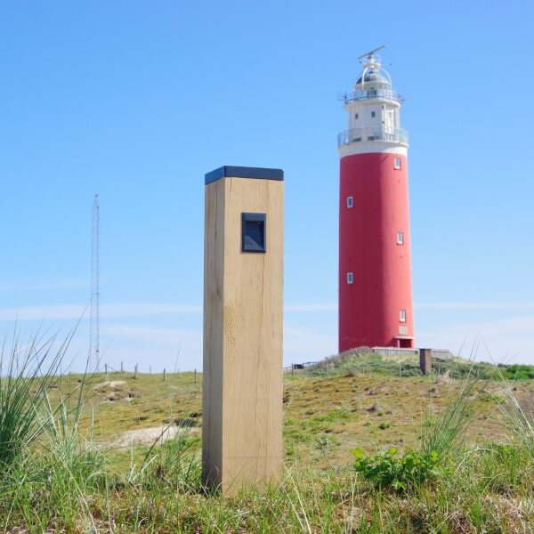 Wooden path lighting with solar panel on the dunes next to the lighthouse
